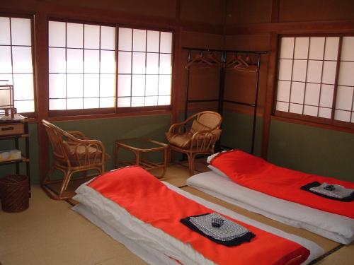 Tempat tidur dalam kamar di Onsen Inn 36So