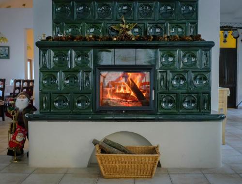 a fireplace in a living room with a fire at Pensiunea Sibiel in Sibiel