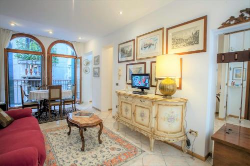 een woonkamer met een rode bank en een tv bij San Marco Romantic Dream in Venetië