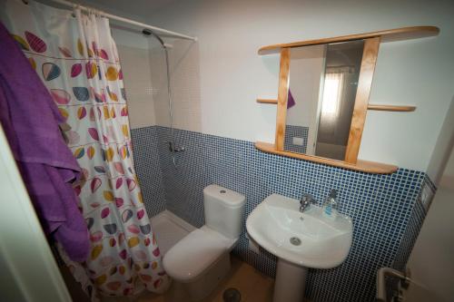 a bathroom with a sink and a toilet and a shower at Casa Lola in Agaete