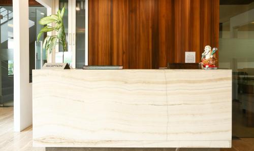 a wooden counter in a building with a statue on it at Treebo Tryst Eden Residency in Gurgaon