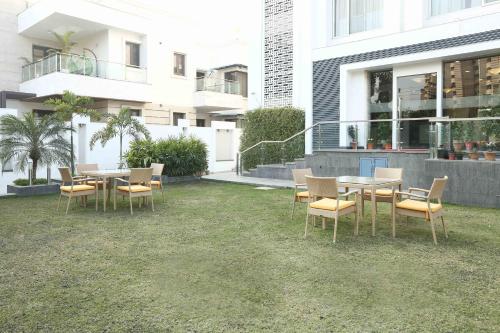 a group of tables and chairs in front of a building at Treebo Tryst Eden Residency in Gurgaon