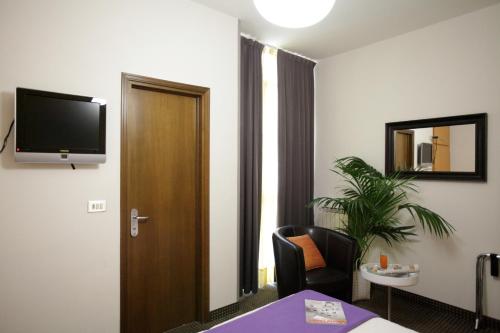 una camera d'albergo con TV a parete di Art Hotel a Mirano