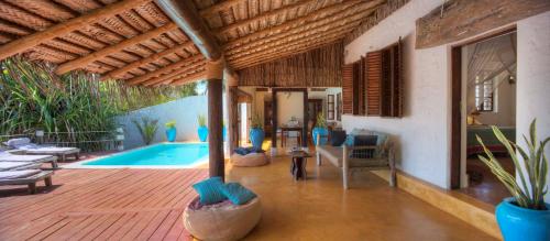 a villa with a swimming pool and a living room at Matemwe Beach House in Matemwe