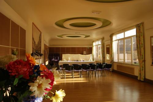 a room with a dining room with a table and chairs at Hôtel Saint - Pierre in Villedieu-les-Poëles