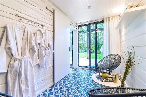 a bathroom with a blue tiled floor and a rack with towels at Hapsal Spa Villas in Haapsalu
