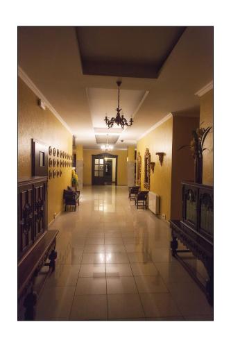 an empty hallway with tables and chairs in a building at Hotel Lord Dębica in Dębica