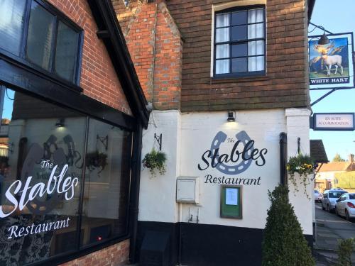 a building with a sign that reads the shakers restaurant at The White Hart pub and rooms in Cranleigh