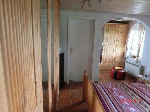 a bedroom with a bed and a hallway with a mirror at Ferienhaus im Ederbergland in Hatzfeld