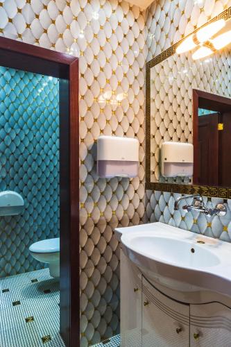a bathroom with a sink and a mirror at Hotel Palas in Kazanlŭk