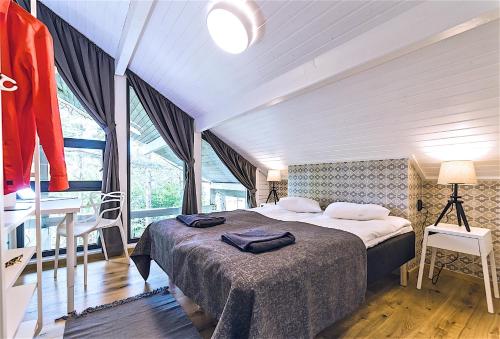 a bedroom with a bed and a table and a window at Hapsal Spa Villas in Haapsalu