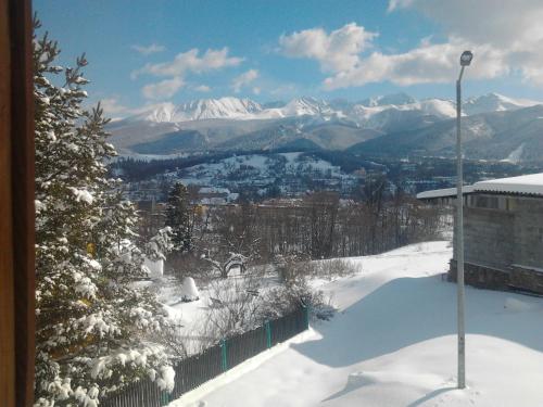 a view of a snow covered city and mountains at Janickowa Ostoja - Noclegi w Zakopanem in Zakopane