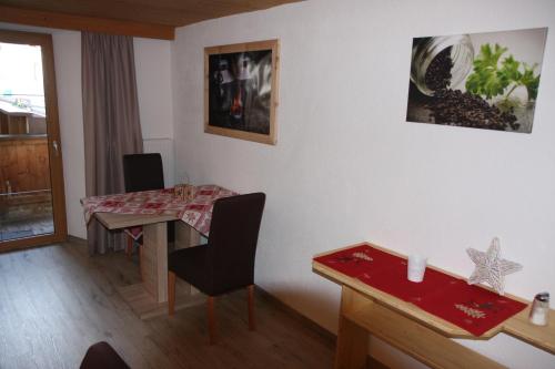 a living room with a table and a dining room at Haus Eckhart in Kaunertal