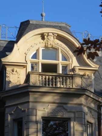 a building with a balcony on top of it at Villa Vier Jahreszeiten in Crimmitschau
