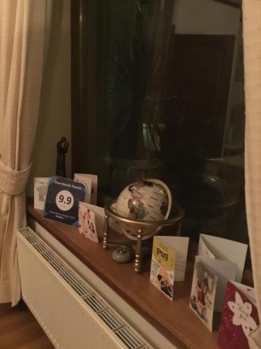 a shelf with a clock and cards on it at Thornbank House in Stranraer