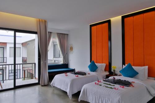a hotel room with two beds and a balcony at Central Corner d'Angkor in Siem Reap