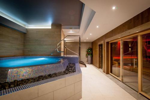 a swimming pool in the middle of a building at Woodbury Park Hotel & Spa in Exeter