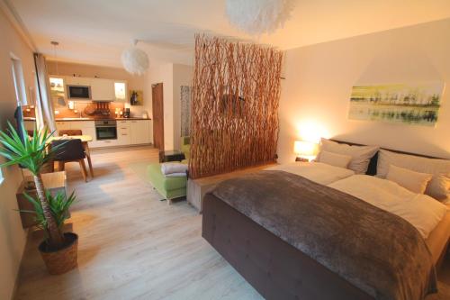 a bedroom with a bed and a living room at Haus am Stadtturm Apartments in Traben-Trarbach