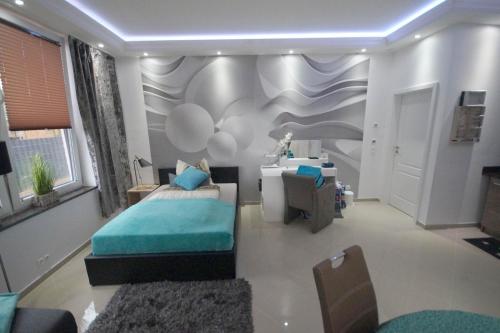 a bedroom with a bed and a desk in it at Pension / Zimmervermietung Wasbek in Wasbek
