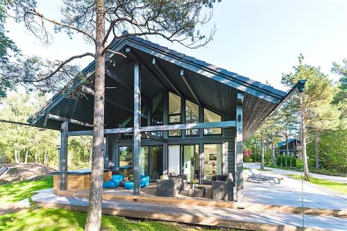 a house with a large window and a tree at Hapsal Spa Villas in Haapsalu