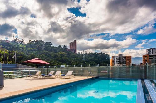 a swimming pool on the roof of a building at La Quinta by Wyndham Medellin in Medellín