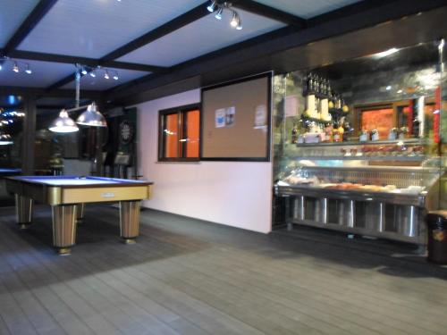 a restaurant with a pool table and a bar at Pedras Lavradas in Teixeira de Baixo