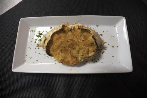 a white plate with a piece of food on it at Hotel Palm Beach in Pointe-Noire