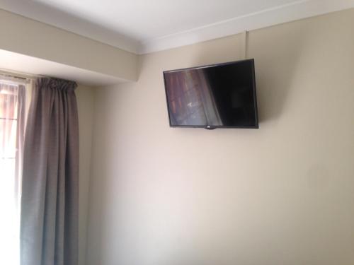 a flat screen tv on the wall of a room at Murdoch Station Bed & Breakfast in Perth
