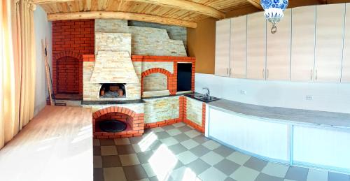 a brick oven in the middle of a room at Sadyba Smotrytska Perlyna in Kamianets-Podilskyi