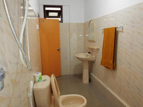 a bathroom with a toilet and a sink at Choona Lodge 'view of sigiriya & pidurangala with sunrise' in Sigiriya