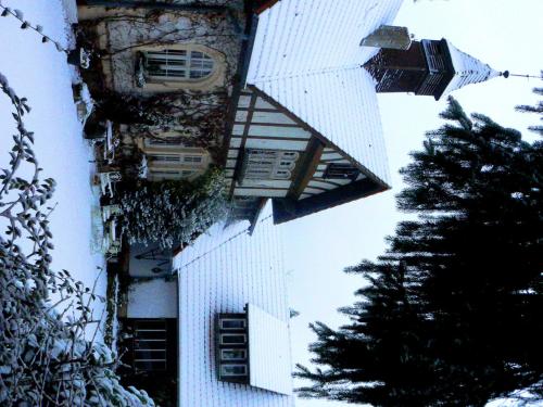 a tall white building with a tree in front of it at Chambre d'hôtes du Moulin de Landonvillers in Courcelles-Chaussy