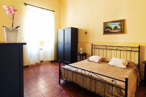 a bedroom with a bed and a large window at Sea Shell in Riposto