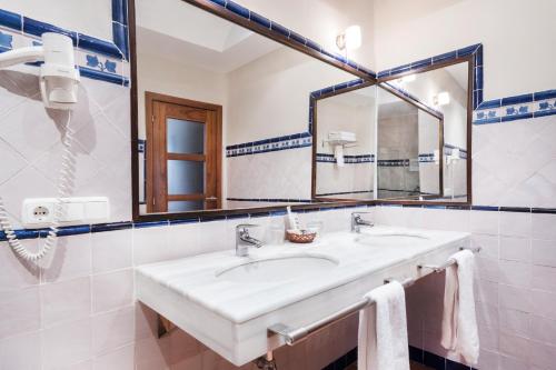 a bathroom with a sink and a mirror at Casa Palacio Pilar del Toro in Granada