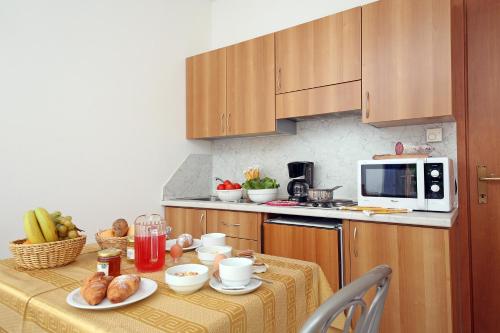 a kitchen with a table with food on it at Hotel Residence La Pertica in Tremosine Sul Garda