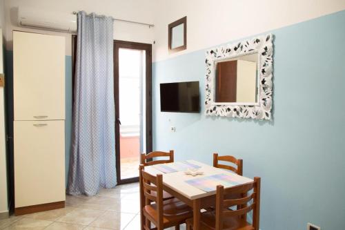 a dining room with a table and a mirror at By the Sea in Terrasini