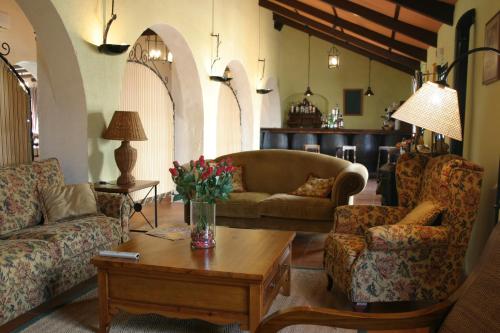 a living room with two couches and a coffee table at Mesón de la Molinera in Arcos de la Frontera