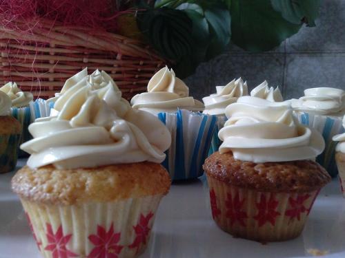 a group of cupcakes with white frosting on them at Hotel Rural El Algaire in Arquera de Salas