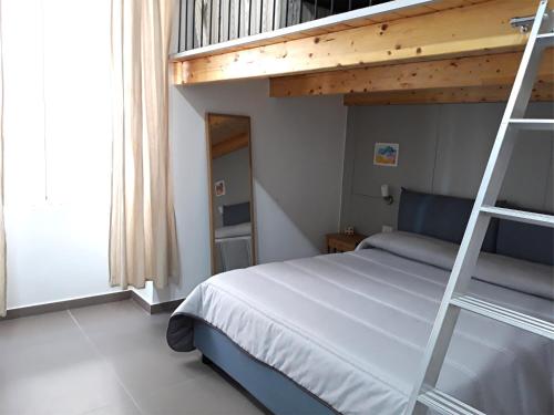 a bedroom with a bunk bed with a ladder at B&B City Center in Naples