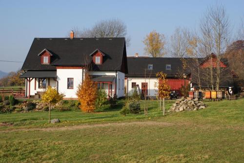 a large white house with a black roof at Guest House K74 in Jablonné v Podještědí