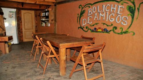 a wooden table and chairs in a restaurant at Apart Piedra Libre in Tandil