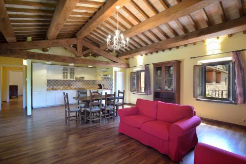 a living room with a red couch and a table at Villa Santa Maria Deruta in Deruta