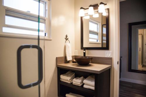 a bathroom with a sink and a mirror at The Landing at Morro Bay in Morro Bay