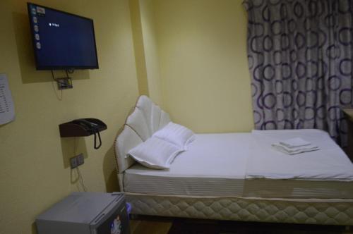 a hospital room with a bed and a tv at Hotel Reyadha International in Cox's Bazar