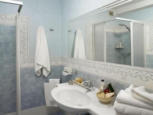 a bathroom with a sink and a mirror at Hotel Poker in Riccione