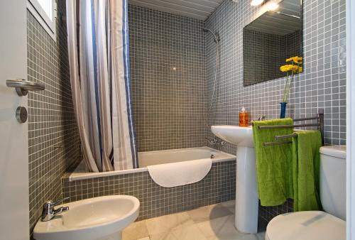 a bathroom with a sink and a toilet and a tub at DescubreHome Sol Town Center Private Terrace in Seville