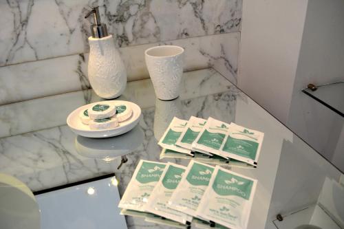 a marble table with pamphlets and a vase on it at Residence Master Suite en Porteño Building in Buenos Aires