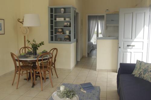 a living room and kitchen with a table and chairs at Bakagiannis Apartments in Parga