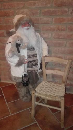 a statue of a monkey standing next to a chair at Residenza Airone in Vicenza