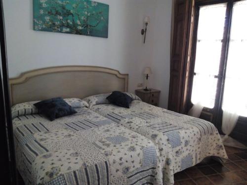 a bedroom with a bed with two pillows on it at El Sueño de Lucrecia in Villarrubia de Santiago