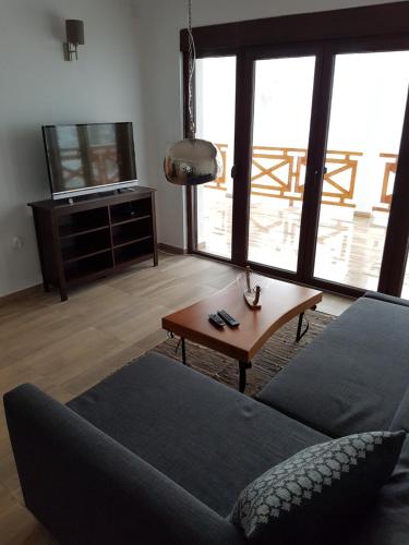 a living room with a couch and a table at Vila ANA in Divčibare